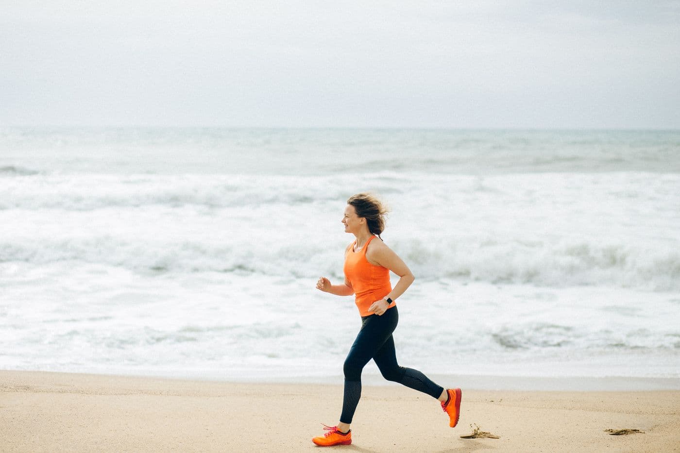 A runner in motion beside the ocean